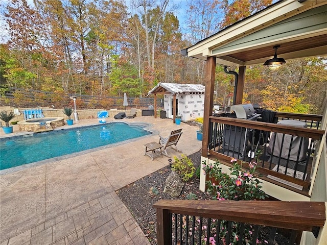 view of pool with an outdoor structure, a patio area, ceiling fan, and a jacuzzi