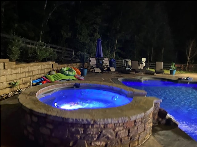 view of pool with an in ground hot tub