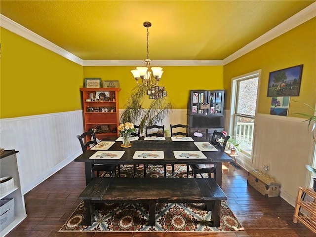 dining room featuring crown molding, a chandelier, and dark wood-type flooring