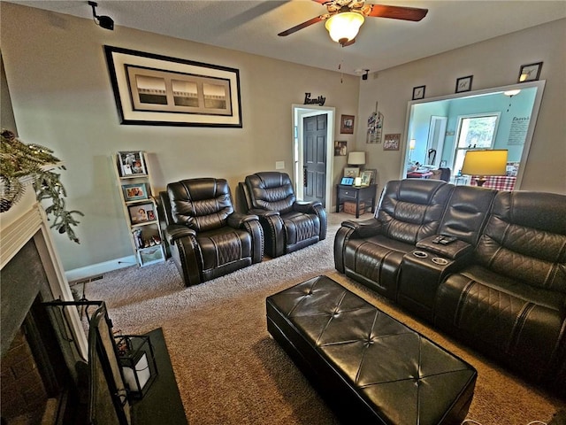 carpeted home theater with ceiling fan