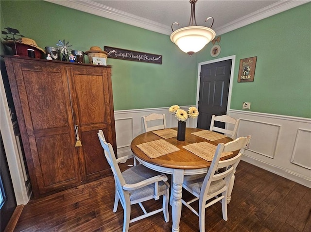 dining space with crown molding and dark hardwood / wood-style floors