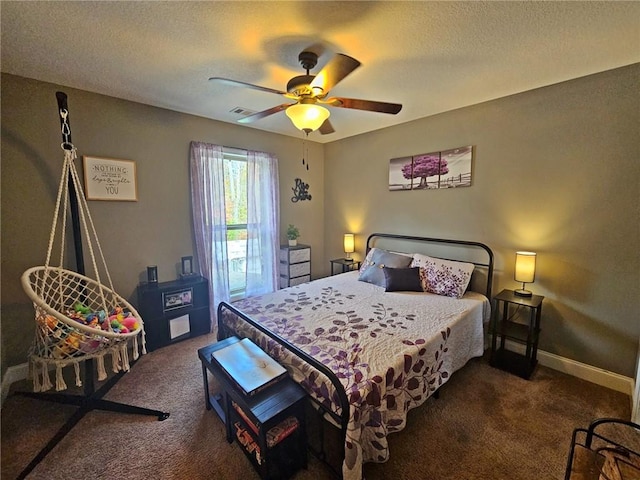 carpeted bedroom with a textured ceiling and ceiling fan