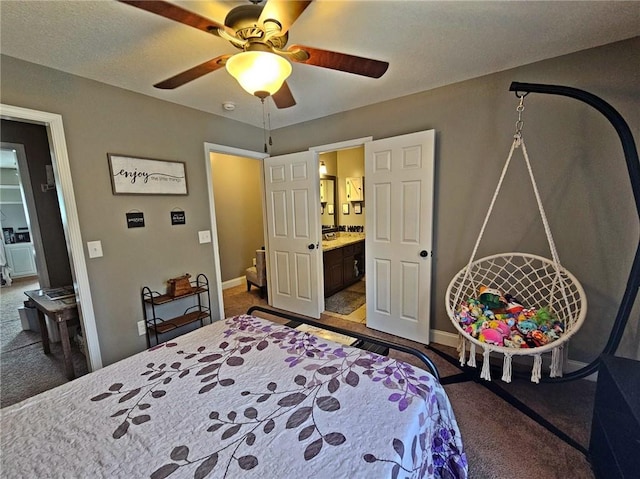 carpeted bedroom with ceiling fan and ensuite bathroom