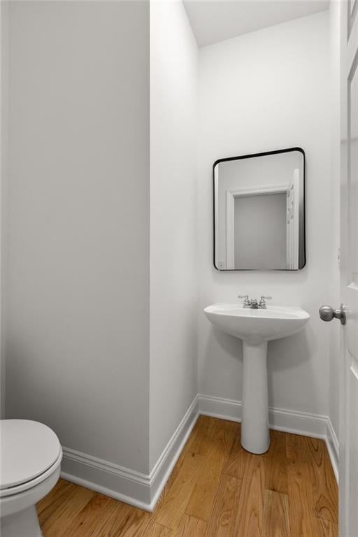 90 Grove Park Ln, Woodstock, GA 30189 - bathroom with baseboards, wood finished floors, and toilet