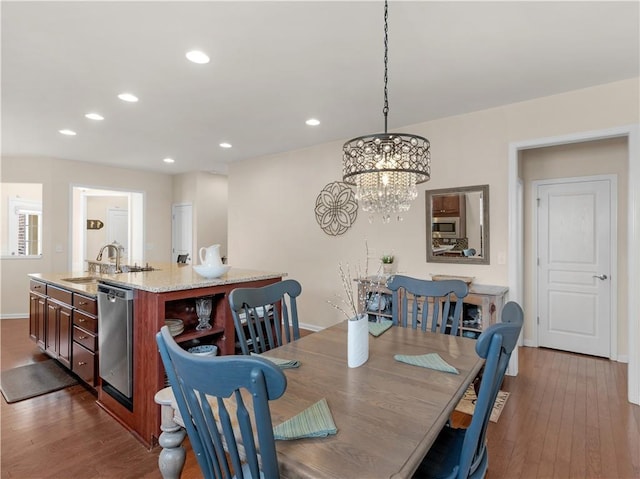 dining area with recessed lighting, an inviting chandelier, baseboards, and wood finished floors