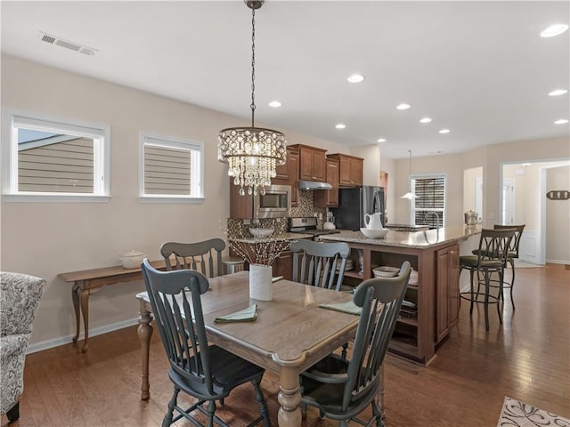 dining space featuring recessed lighting, visible vents, wood-type flooring, and baseboards