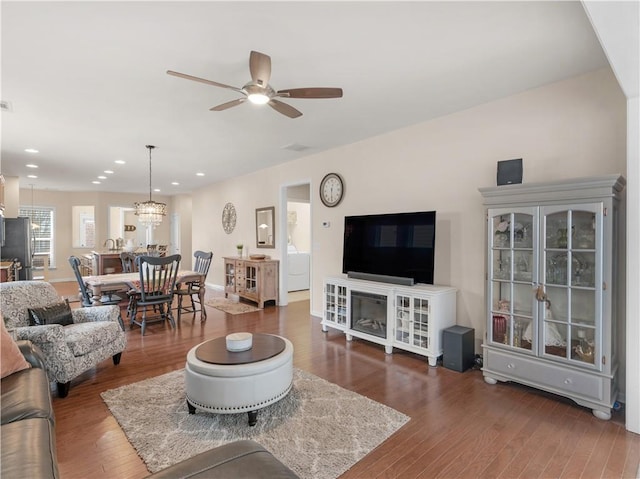 living area with visible vents, recessed lighting, ceiling fan with notable chandelier, wood finished floors, and washer / clothes dryer