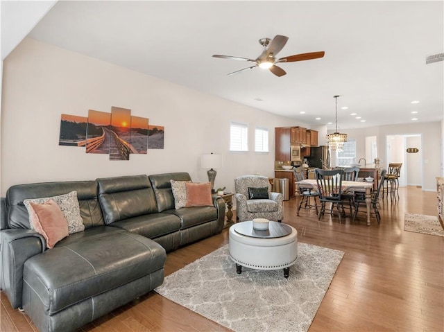 living area featuring recessed lighting, light wood-type flooring, visible vents, and ceiling fan