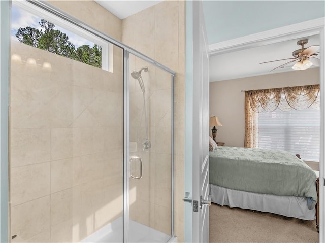 ensuite bathroom featuring a stall shower, ensuite bath, and ceiling fan