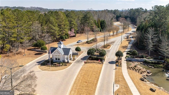 birds eye view of property featuring a wooded view