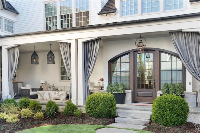 view of exterior entry with a porch