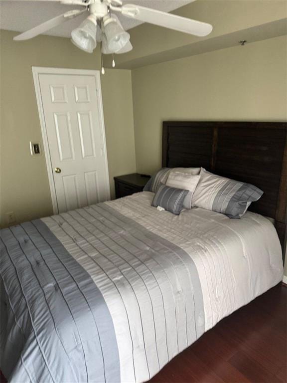 bedroom featuring a ceiling fan and wood finished floors