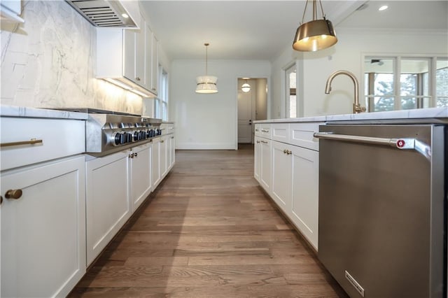 kitchen featuring white cabinetry, stainless steel dishwasher, and hanging light fixtures