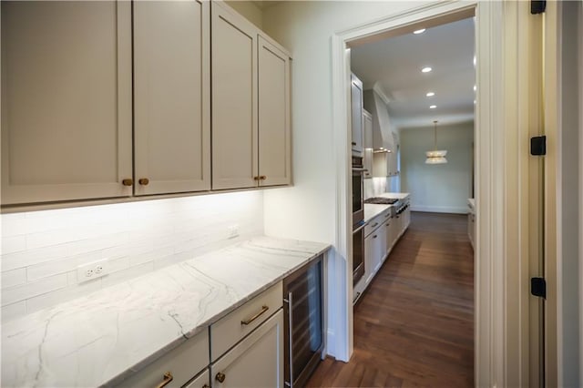 bar featuring dark hardwood / wood-style floors, beverage cooler, stainless steel oven, wall oven, and light stone counters