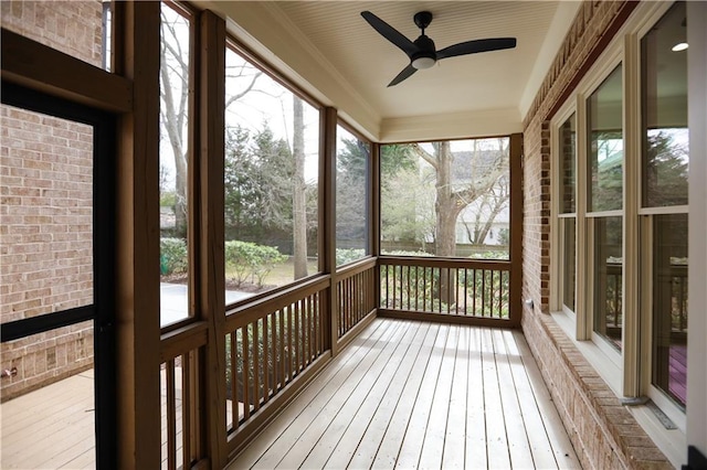 unfurnished sunroom featuring ceiling fan