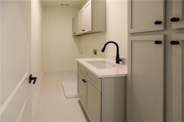 laundry area featuring cabinets, sink, and washer hookup