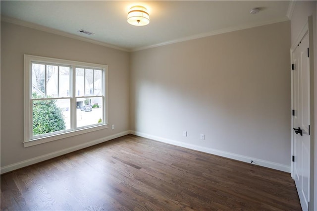 empty room with crown molding and dark hardwood / wood-style floors