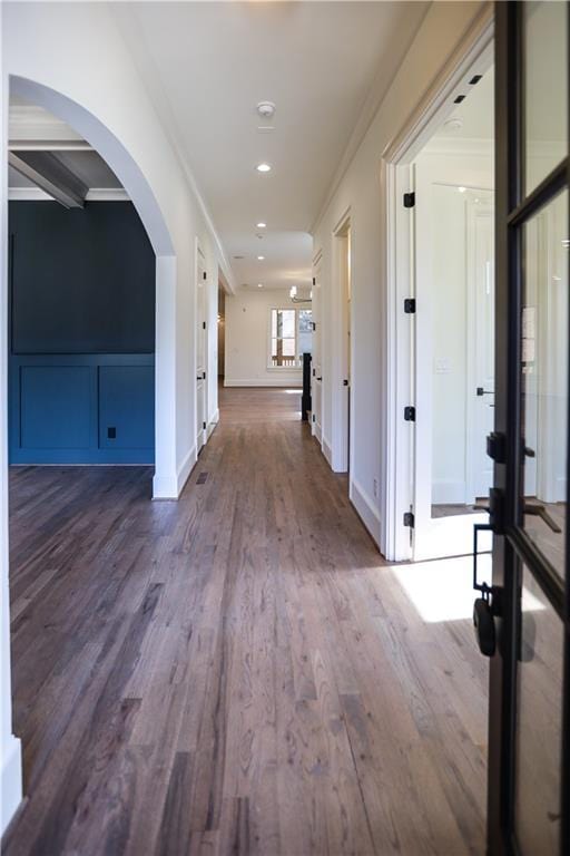 hall with dark hardwood / wood-style flooring and crown molding