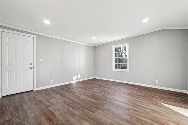 spare room with dark wood-type flooring and crown molding