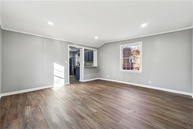 unfurnished living room featuring dark wood-type flooring and vaulted ceiling