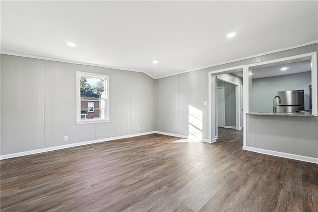 unfurnished living room featuring crown molding and dark hardwood / wood-style floors