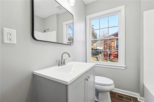 full bathroom featuring plenty of natural light, toilet, vanity, and tub / shower combination