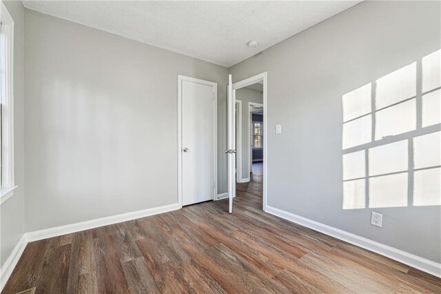 unfurnished room with wood-type flooring