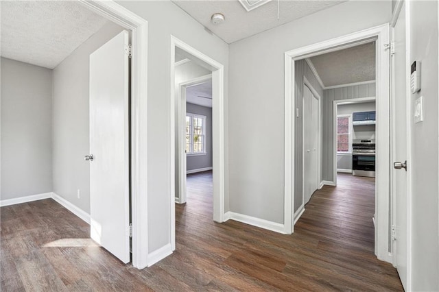 hallway with dark wood-type flooring and a textured ceiling