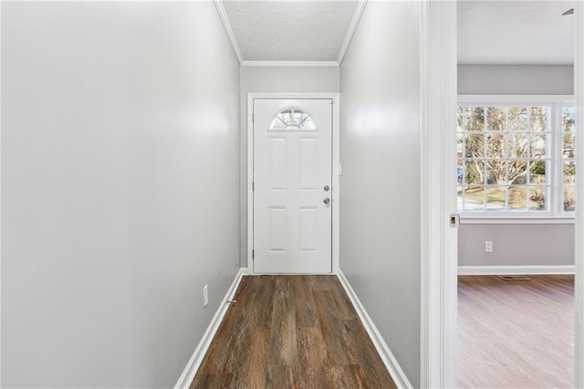 doorway featuring hardwood / wood-style floors, crown molding, and a textured ceiling