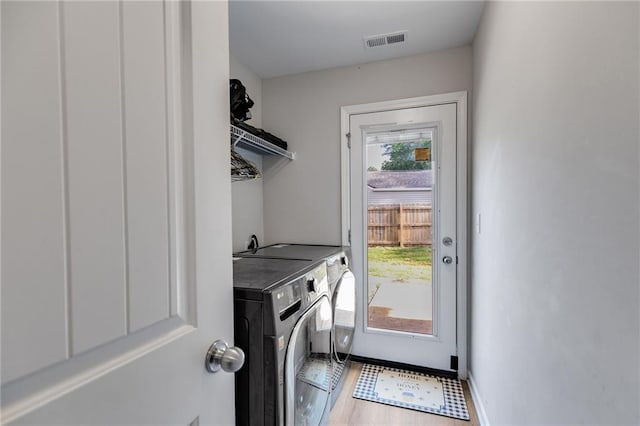 119 Sourwood Ln, Temple, GA 30179 - laundry room featuring laundry area, visible vents, wood finished floors, baseboards, and independent washer and dryer