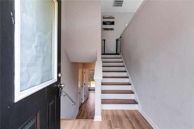 119 Sourwood Ln, Temple, GA 30179 - stairway with baseboards, visible vents, and wood finished floors