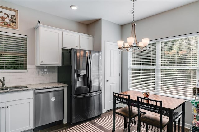 119 Sourwood Ln, Temple, GA 30179 - kitchen featuring backsplash, white cabinets, dark wood-style floors, a notable chandelier, and stainless steel appliances
