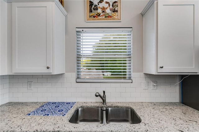 119 Sourwood Ln, Temple, GA 30179 - kitchen with a sink, decorative backsplash, light stone countertops, and white cabinets