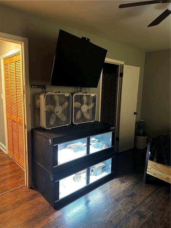 bedroom with ceiling fan and dark hardwood / wood-style floors