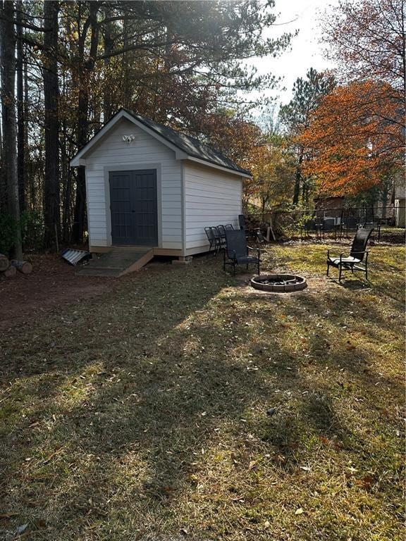 view of yard with a fire pit and a storage unit