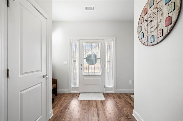 entrance foyer featuring hardwood / wood-style flooring, baseboards, and visible vents