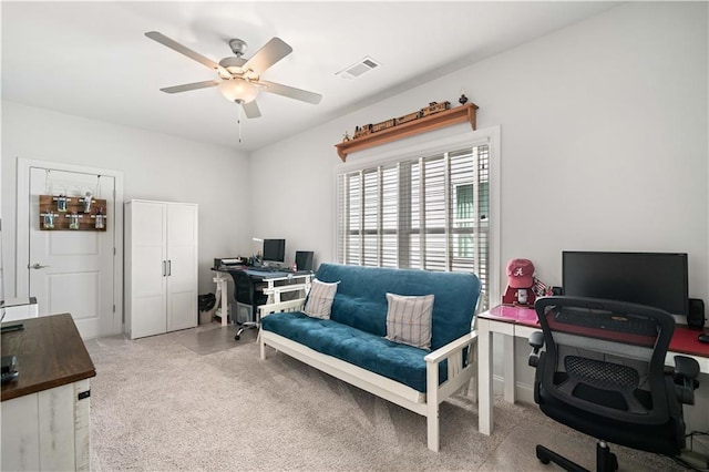 carpeted home office with visible vents and a ceiling fan