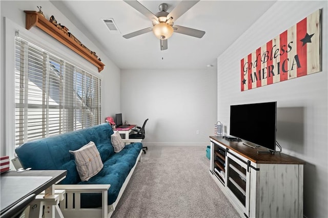 living area with a ceiling fan, carpet, visible vents, and baseboards