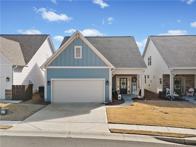 craftsman house with board and batten siding, driveway, a shingled roof, and a garage