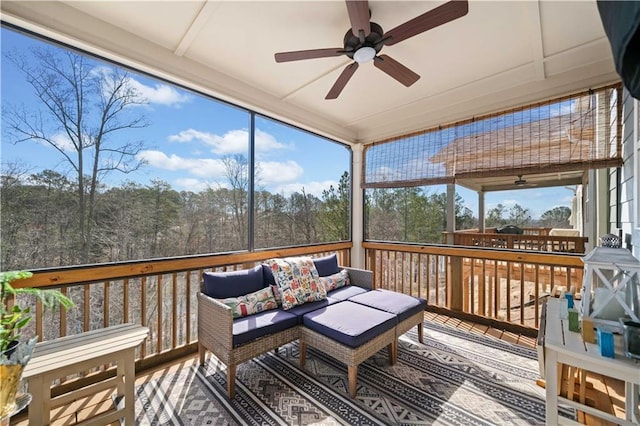 sunroom featuring a ceiling fan