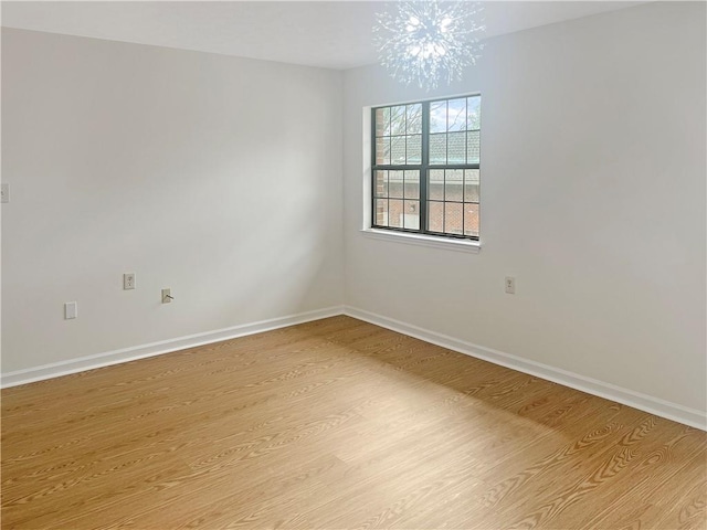 475 Mount Vernon Hwy NE Unit C230, Sandy Springs, GA 30328 - spare room with light wood-type flooring and a chandelier