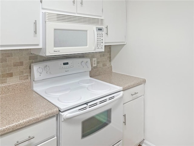 475 Mount Vernon Hwy NE Unit C230, Sandy Springs, GA 30328 - kitchen featuring white appliances, light countertops, white cabinets, and decorative backsplash