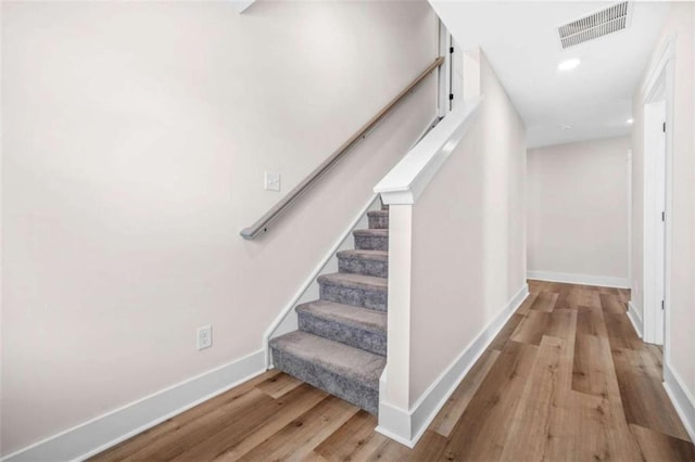 stairs featuring recessed lighting, wood finished floors, visible vents, and baseboards