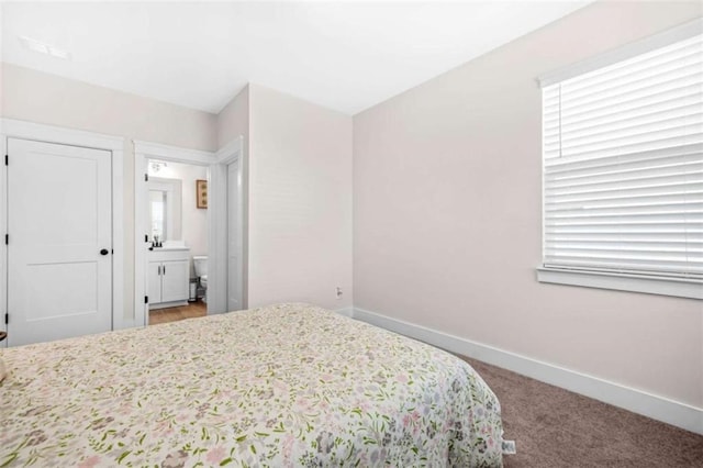 carpeted bedroom featuring baseboards