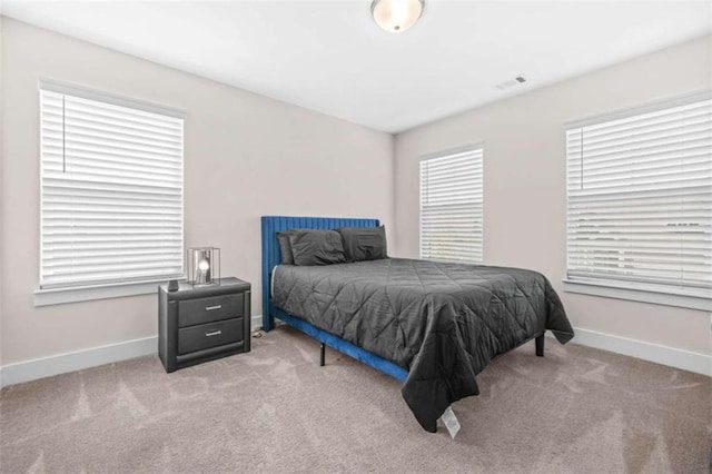 bedroom with carpet, visible vents, and baseboards