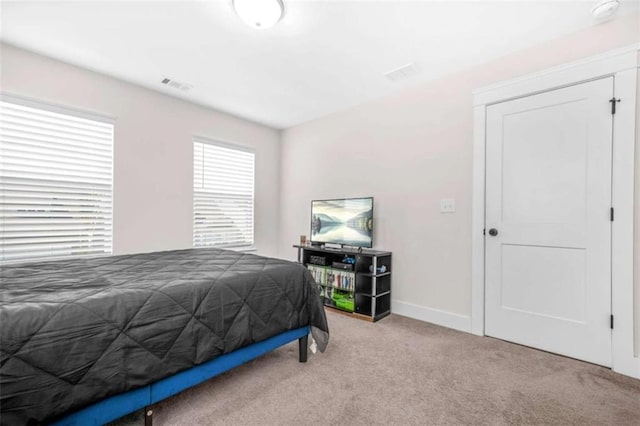carpeted bedroom with visible vents and baseboards