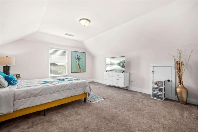 bedroom featuring lofted ceiling, baseboards, visible vents, and carpet floors