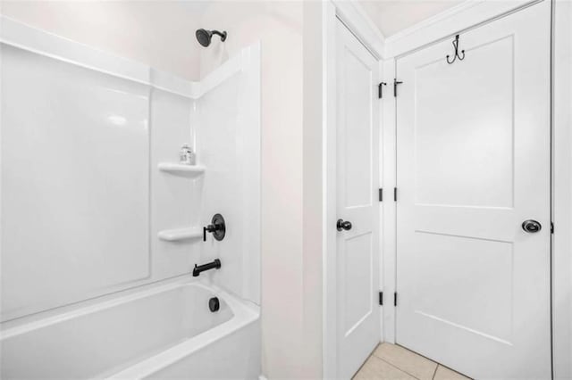 bathroom with tile patterned floors and shower / washtub combination
