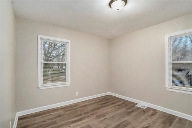 unfurnished room with wood-type flooring