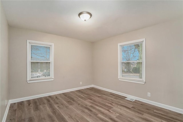 empty room featuring hardwood / wood-style flooring and a wealth of natural light